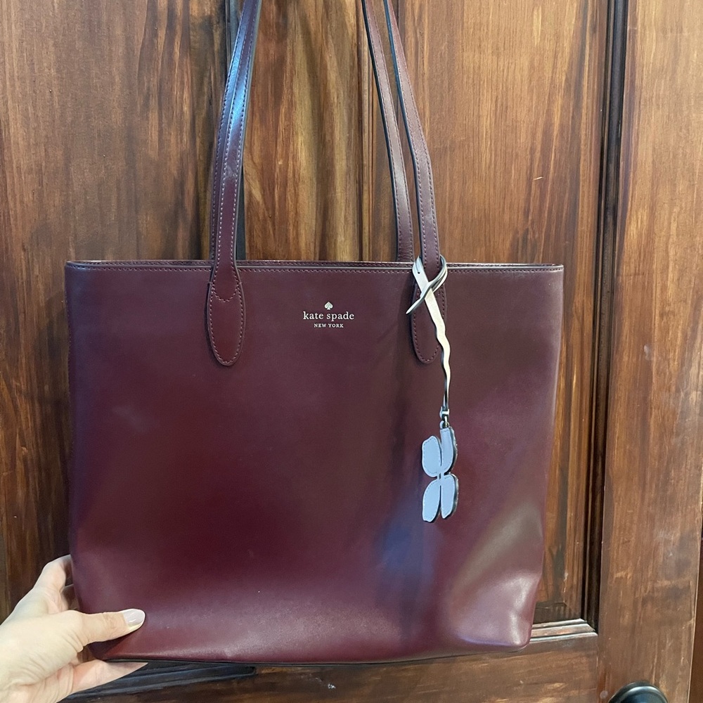 Kate spade medium Tote with charm. wine color